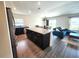 Open-concept kitchen with granite island flowing into the living area, perfect for entertaining at 3838 Whitetail Ct, St Cloud, FL 34772