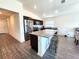 Open kitchen featuring stainless steel appliances, dark cabinetry, and island with granite countertops at 3838 Whitetail Ct, St Cloud, FL 34772