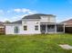 The backyard is large and grassy with an enclosed patio and dark wooden fence at 408 Becky St, Orlando, FL 32824