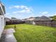 View of the expansive backyard with lush green grass and a brick patio at 408 Becky St, Orlando, FL 32824