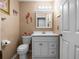 Compact bathroom features a white vanity and toilet with flamingo themed decorations at 408 Becky St, Orlando, FL 32824