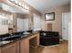A relaxing bathroom featuring a black marble tub and a vanity with a black countertop at 408 Becky St, Orlando, FL 32824