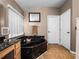 A relaxing bathroom featuring a black marble tub and vanity with window and towel rack at 408 Becky St, Orlando, FL 32824
