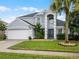 Two-story home featuring a well-manicured lawn and an attached two car garage at 408 Becky St, Orlando, FL 32824