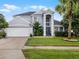 Charming two-story home featuring a well-manicured lawn, a two-car garage, and attractive landscaping at 408 Becky St, Orlando, FL 32824