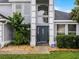 Close-up of the front door with decorative sidelights, surrounded by manicured landscaping and an ADT security sign at 408 Becky St, Orlando, FL 32824