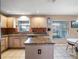 Eat-in kitchen featuring granite countertops, an island, and bright natural light at 408 Becky St, Orlando, FL 32824