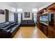 Bright living room featuring wood floors, high ceilings, and a media center at 408 Becky St, Orlando, FL 32824