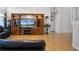 Well-lit living room with an entertainment center and wood flooring at 408 Becky St, Orlando, FL 32824
