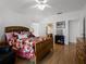 Cozy main bedroom featuring hardwood floors, a fireplace, and access to an ensuite bathroom at 408 Becky St, Orlando, FL 32824