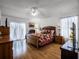 Spacious main bedroom with hardwood floors, a ceiling fan, and light and airy curtains at 408 Becky St, Orlando, FL 32824