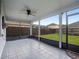 The screened patio has tiled floors, ceiling fan and view of backyard at 408 Becky St, Orlando, FL 32824
