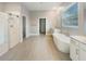 Luxurious bathroom featuring a soaking tub, walk-in shower, and double vanities at 4116 Se 9Th Ave, Ocala, FL 34480