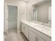 Bathroom featuring dual sinks with quartz countertops and a doorway into the shower at 4116 Se 9Th Ave, Ocala, FL 34480
