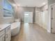 Elegant bathroom with a soaking tub, a walk-in shower, and double sinks at 4116 Se 9Th Ave, Ocala, FL 34480