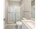 Modern bathroom with a glass-enclosed shower, toilet, and vanity with quartz countertop at 4116 Se 9Th Ave, Ocala, FL 34480