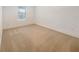 This is a clean and cozy bedroom with neutral carpet, white walls, and a bright window at 4116 Se 9Th Ave, Ocala, FL 34480