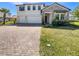 Beautiful two-story home with brick driveway, stone accents, a two-car garage, and meticulously maintained landscaping at 4116 Se 9Th Ave, Ocala, FL 34480