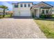 Beautiful two-story home featuring a brick driveway, stone accents, a two-car garage, and well-manicured landscaping at 4116 Se 9Th Ave, Ocala, FL 34480