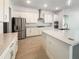 Modern kitchen boasting white cabinetry, stainless steel appliances, a center island, and elegant quartz countertops at 4116 Se 9Th Ave, Ocala, FL 34480