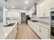 Modern kitchen featuring white cabinetry, a center island, stainless steel appliances, and quartz countertops at 4116 Se 9Th Ave, Ocala, FL 34480