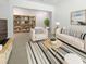 Bright living room boasts stylish furniture, a striped rug, and a decorative bookshelf at 4116 Se 9Th Ave, Ocala, FL 34480