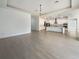 Open-concept living space with tile floors connecting the living room and a modern kitchen with stainless steel appliances at 4116 Se 9Th Ave, Ocala, FL 34480