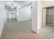 Spacious living space with tile flooring leading to a bathroom and a bright window in the background at 4116 Se 9Th Ave, Ocala, FL 34480