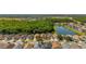 An aerial view displays neighborhood homes with access to green spaces, lakes, and nearby roadways at 4640 Eagle Peak Dr, Kissimmee, FL 34746
