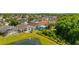 An aerial view displays a home with a screened-in pool with lush greenery and a pond nearby at 4640 Eagle Peak Dr, Kissimmee, FL 34746
