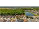 An aerial view displays neighborhood homes with access to green spaces, lakes, and nearby roadways at 4640 Eagle Peak Dr, Kissimmee, FL 34746