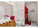Functional bathroom features a sink, toilet and a shower with a Mickey Mouse curtain at 4640 Eagle Peak Dr, Kissimmee, FL 34746