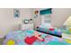 Bright bedroom with twin beds featuring colorful comforters at 4640 Eagle Peak Dr, Kissimmee, FL 34746