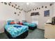 Bedroom with twin beds featuring colorful comforters and decorations at 4640 Eagle Peak Dr, Kissimmee, FL 34746