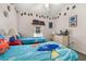 Cozy bedroom featuring twin beds with playful character-themed bedding and colorful decorations at 4640 Eagle Peak Dr, Kissimmee, FL 34746