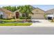 Charming single-story home featuring a well-manicured lawn and a decorative palm tree in the front yard at 4640 Eagle Peak Dr, Kissimmee, FL 34746