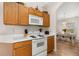 The kitchen features wood cabinets and white appliances, creating a cozy and functional space at 4640 Eagle Peak Dr, Kissimmee, FL 34746