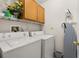 Laundry room equipped with washer, dryer, ironing board, and storage cabinets at 4640 Eagle Peak Dr, Kissimmee, FL 34746