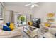 Bright living room with comfortable seating, a ceiling fan, and sliding glass doors that lead to the pool area at 4640 Eagle Peak Dr, Kissimmee, FL 34746