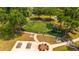 Aerial view of a playground with green turf, swings, a slide, picnic tables and an American flag at 4640 Eagle Peak Dr, Kissimmee, FL 34746