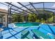 Inviting screened-in pool with lush landscaping and ample space for entertaining and relaxation at 4640 Eagle Peak Dr, Kissimmee, FL 34746