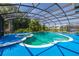 Enclosed pool area featuring a jacuzzi, blue deck, and lush palm trees at 4640 Eagle Peak Dr, Kissimmee, FL 34746