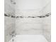Well-lit tub and shower combo with modern tile and fixtures at 4824 Shoshone St, Orlando, FL 32819