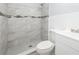 Beautifully updated bathroom with stunning tile design in shower and sleek fixtures at 4824 Shoshone St, Orlando, FL 32819