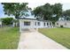Charming single-story home with a well-manicured lawn, covered carport, and updated exterior at 4824 Shoshone St, Orlando, FL 32819