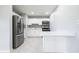 Well-lit kitchen features modern appliances, white cabinets, and a stylish backsplash at 4824 Shoshone St, Orlando, FL 32819