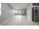 Open-concept living room featuring neutral paint, tile flooring, and ample natural light at 4824 Shoshone St, Orlando, FL 32819