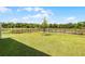 Grassy backyard with black metal fencing overlooking a lake, providing a peaceful outdoor setting at 4829 Cedar Bay Ter, Kissimmee, FL 34746