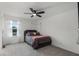 Cozy bedroom with gray carpet, ceiling fan, and a window providing natural light, creating a relaxing atmosphere at 4829 Cedar Bay Ter, Kissimmee, FL 34746