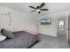 Inviting bedroom with soft gray carpet, a ceiling fan, and a mounted TV, perfect for relaxation and entertainment at 4829 Cedar Bay Ter, Kissimmee, FL 34746
